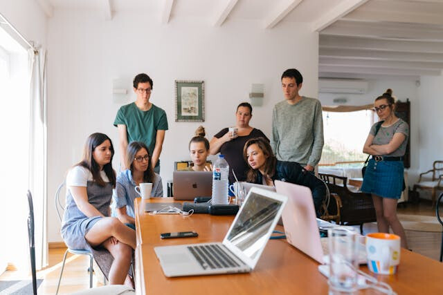 Team clustered around laptops